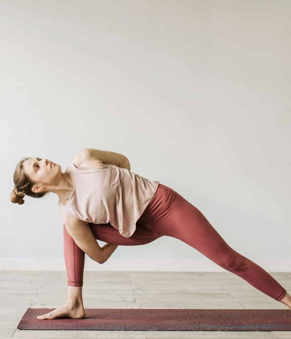 Woman in a calm yoga pose focusing on spinal alignment.
